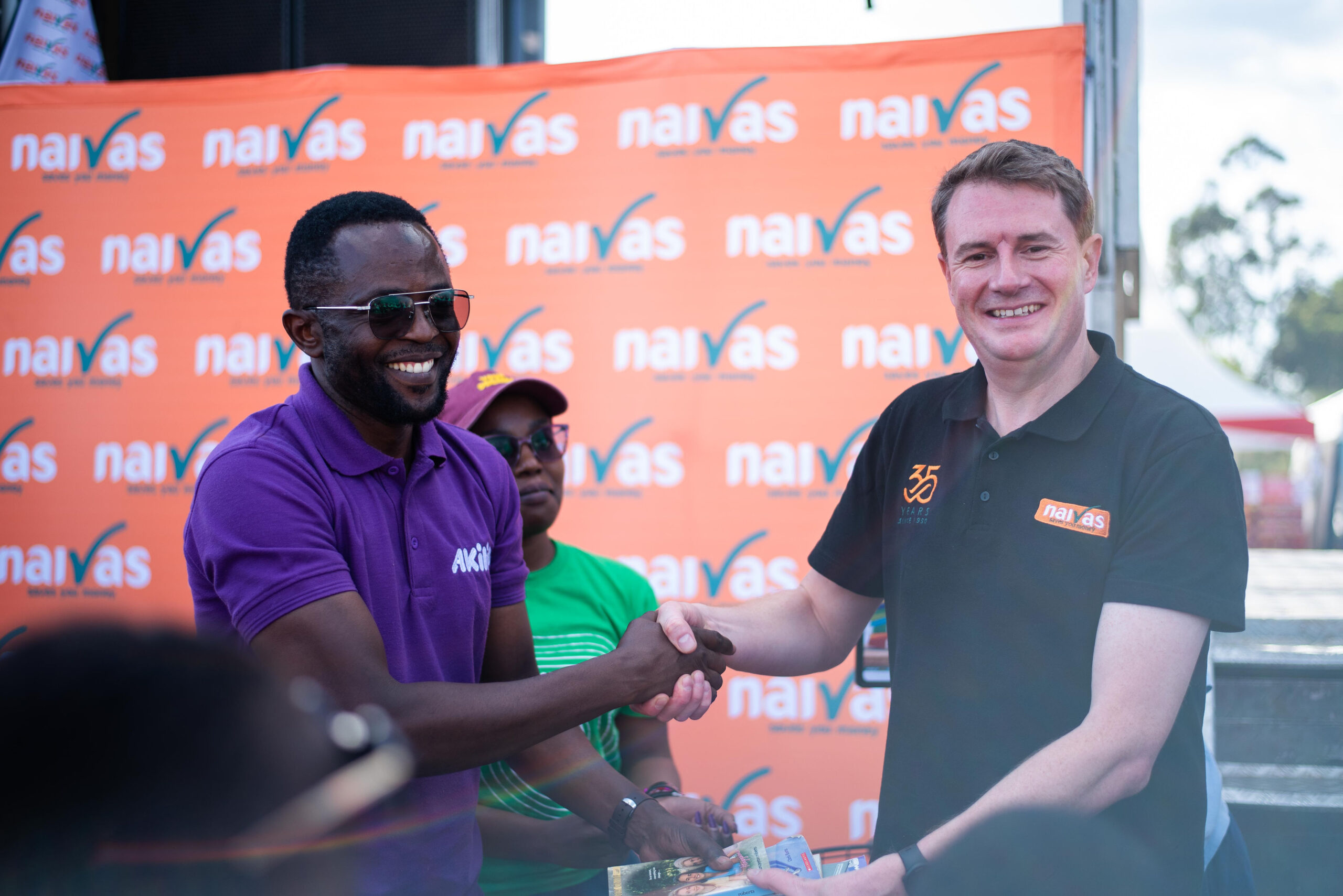Naivas CEO Andres Von Paleske awarding a customer of voucher